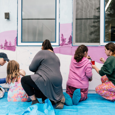 Artist Aistė Rye painting alongside children who are students at the Northwest school for Deaf and Hard-of-Hearing Children.