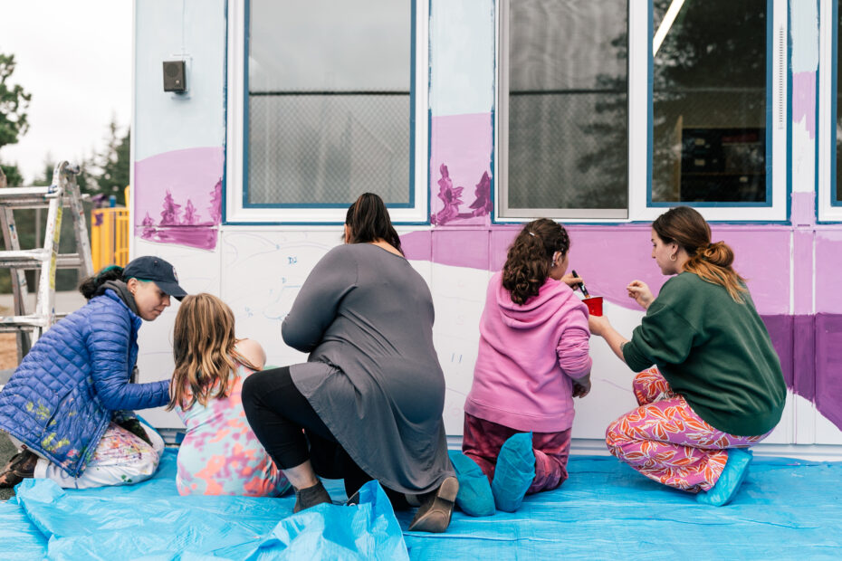 Artist Aistė Rye painting alongside children who are students at the Northwest school for Deaf and Hard-of-Hearing Children.
