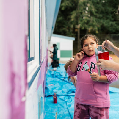 Artist Aistė Rye painting alongside children who are students at the Northwest school for Deaf and Hard-of-Hearing Children.