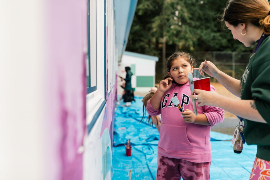 Artist Aistė Rye painting alongside children who are students at the Northwest school for Deaf and Hard-of-Hearing Children.