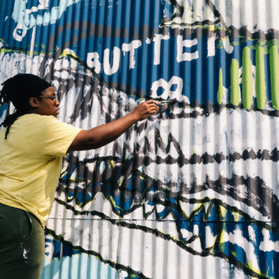Tree painting a mural in Ballard with the MAP students.
