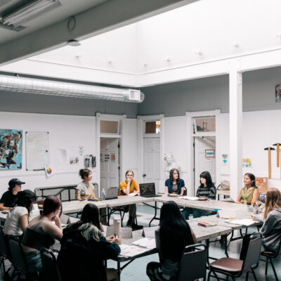 The Summer 2024 Kirkland MAP cohort working together on their mural design inside the Kirkland Arts Center.