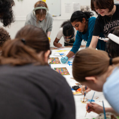 The Fall 2024 Kirkland MAP cohort working together on their mural design inside the Kirkland Arts Center.