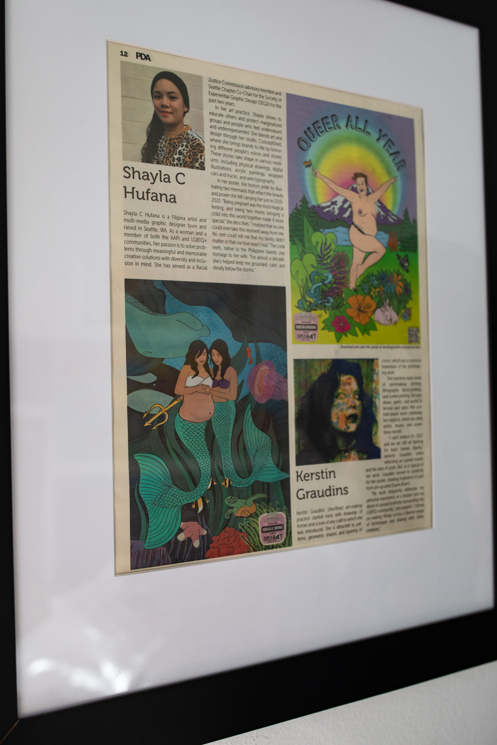 a news article of Shaylas worked frame in her studio.