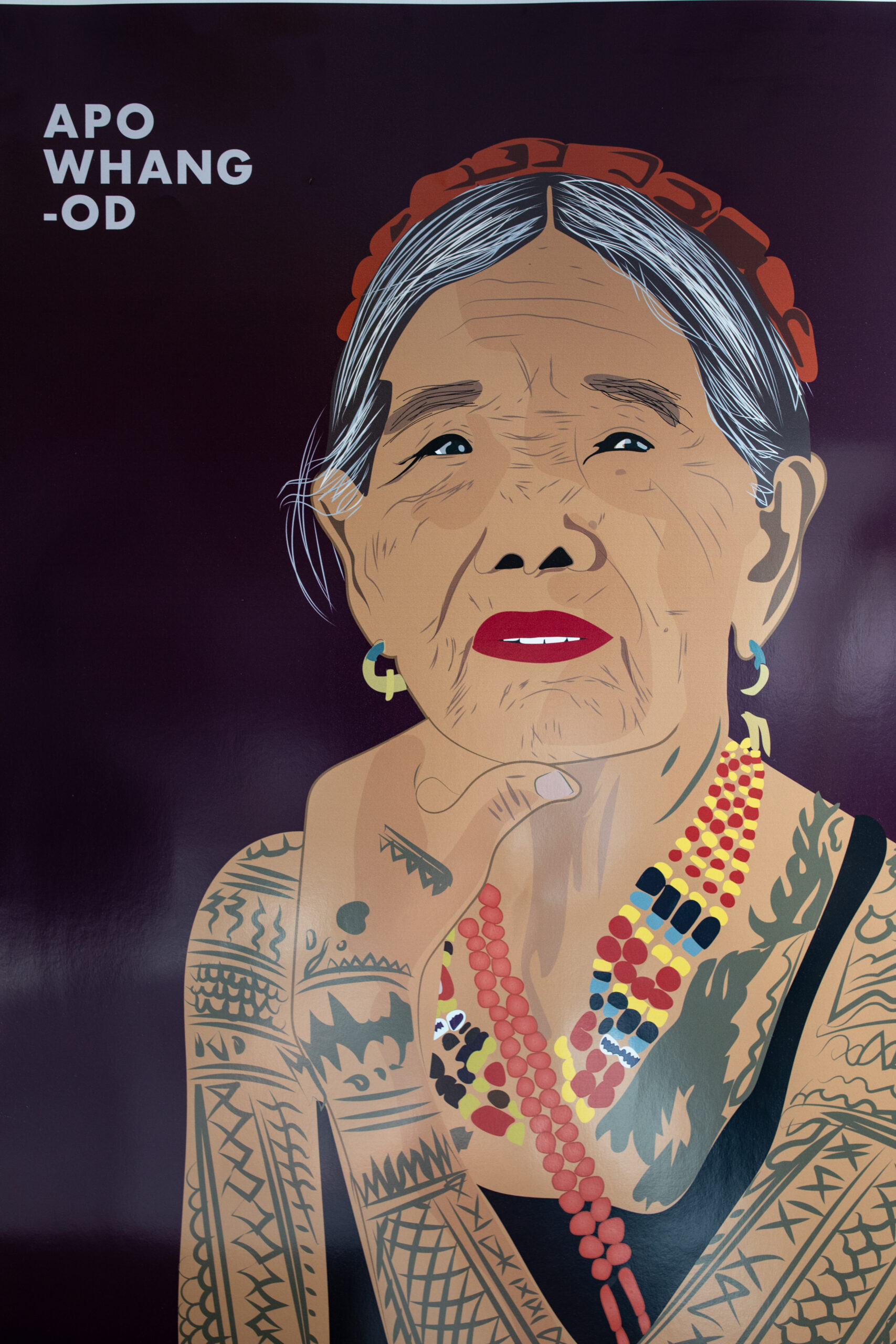 Artwork made by Shayla of Apo Whang-Od, a renowned Filipina tattoo artist, showing her traditional tattoos, jewelry, and thoughtful expression.