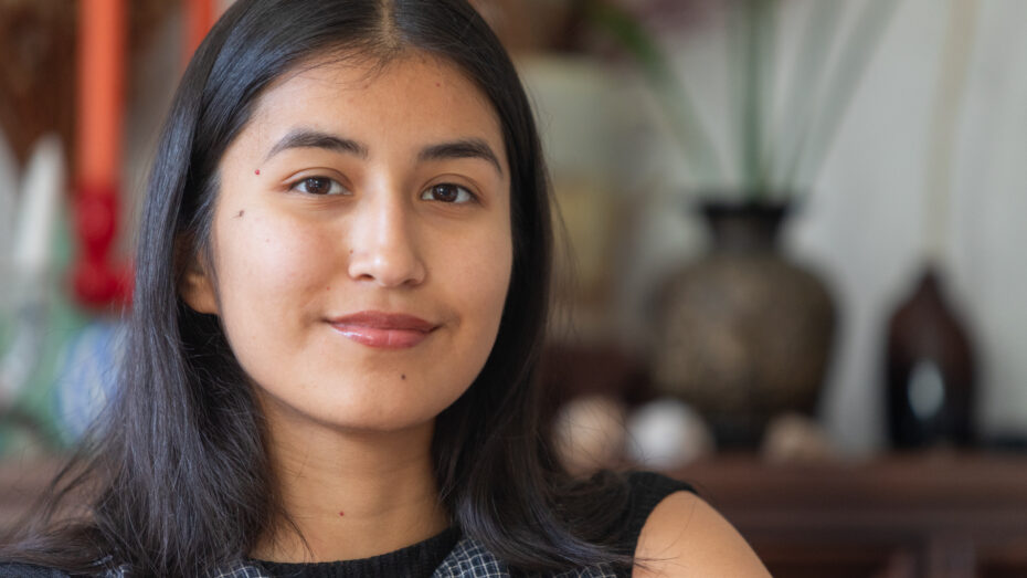 Grace woman with dark hair and tan skin smiling.