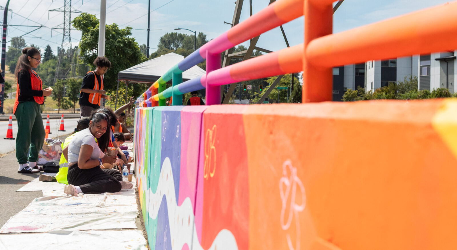 Youth paint a selection of a mural along Martin Luther King Jr. Way S.