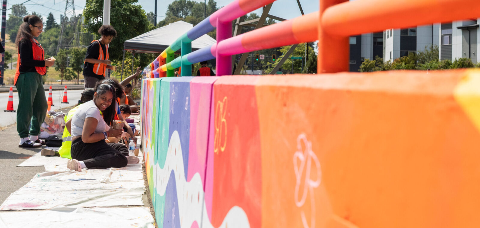 Youth paint a selection of a mural along Martin Luther King Jr. Way S.