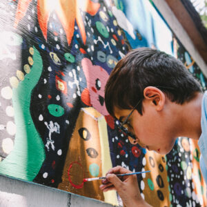 camper painting a mural - close up